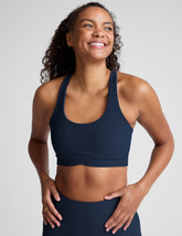blue racerback bra with a scoop neckline
and overlapping hemband detail.