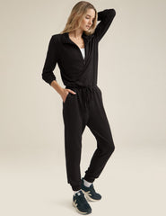 black half zip knit jumpsuit with drawstring at waist