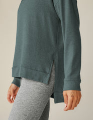 blue v-neck pullover sweater with a high-low detail at waistband and side slits.