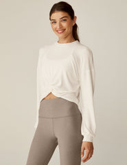 white crew neck relaxed fit cropped pullover with a detailing twist at front waist.