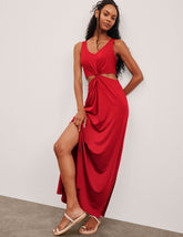 red maxi length tank dress with a v neckline and cutouts at waist.