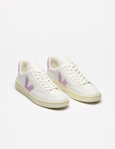 white low top VEJA sneakers with a purple logo detailing.
