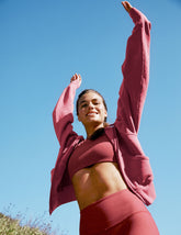 red garment dyed zip-up sweatshirt with pockets.