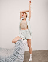 white relaxed fit terry shorts with patch pockets.