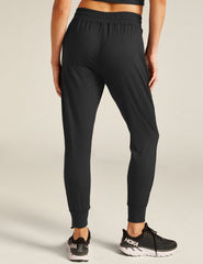 black high-waisted midi joggers with pockets and a drawstring at waistband