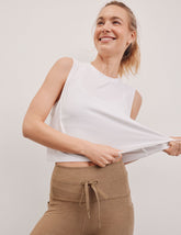 white relaxed fit cropped tank top with a ribbed scooped neckline and ribbed arm holes.