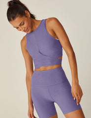 purple high-neck cropped tank top with a crossover detail in the front.
