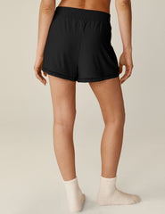 black mini shorts with a lace trim and elastic waistband.