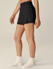 black mini shorts with a lace trim and elastic waistband.
