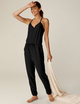 black midi jumpsuit with drawstring at waist and a lace trim at neckline.