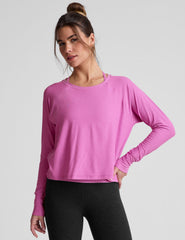 pink long sleeve relaxed fit top with a scoop neckline.