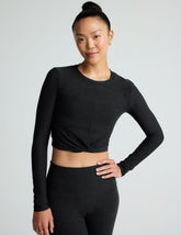 black scoop neck featherweight long sleeve cropped top with a front crossover detail.