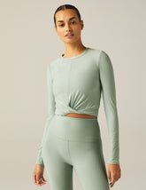 featherweight cropped fitted long sleeve top with a front crossover detail.