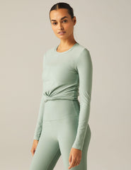 featherweight cropped fitted long sleeve top with a front crossover detail.
