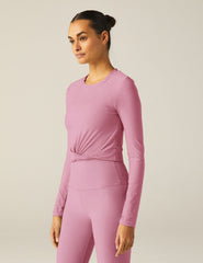 pink long sleeve top with a front twist detail.