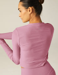 pink long sleeve top with a front twist detail.