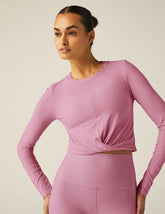 pink long sleeve top with a front twist detail.