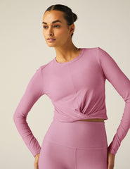 pink long sleeve top with a front twist detail.