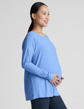blue long sleeve maternity top with a crew neckline.