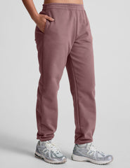 pink sweatpants with pockets and a drawstring at waistband.