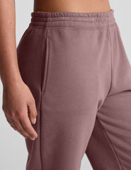 pink sweatpants with pockets and a drawstring at waistband.