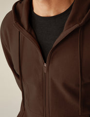 brown zip-up jacket with pockets and a hood.