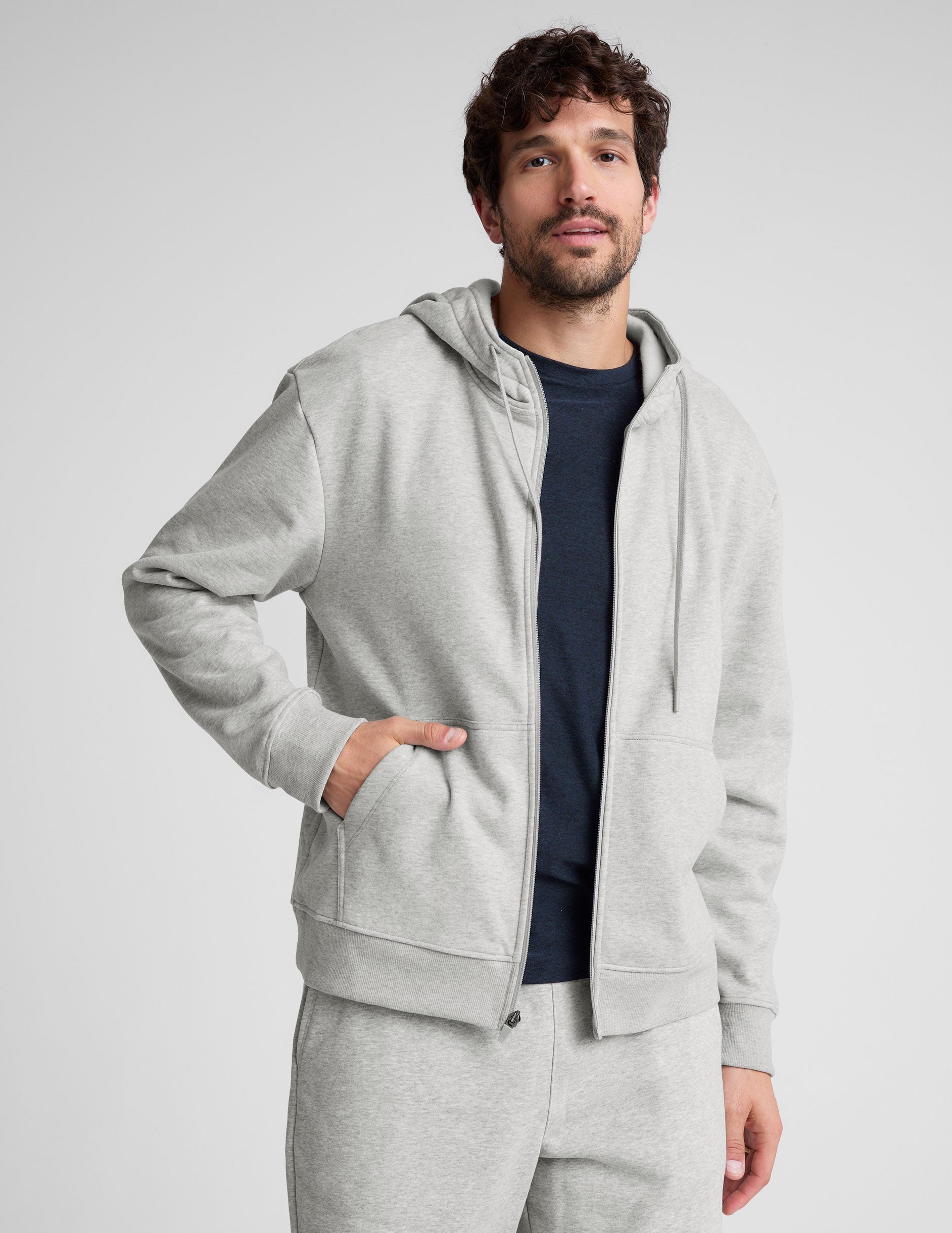 gray zip-up hooded jacket with pockets.