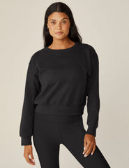 black loose-fitting classic length crew neck sweatshirt.