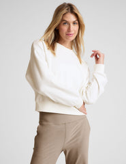 white loose-fitting classic length crew neck sweatshirt.
