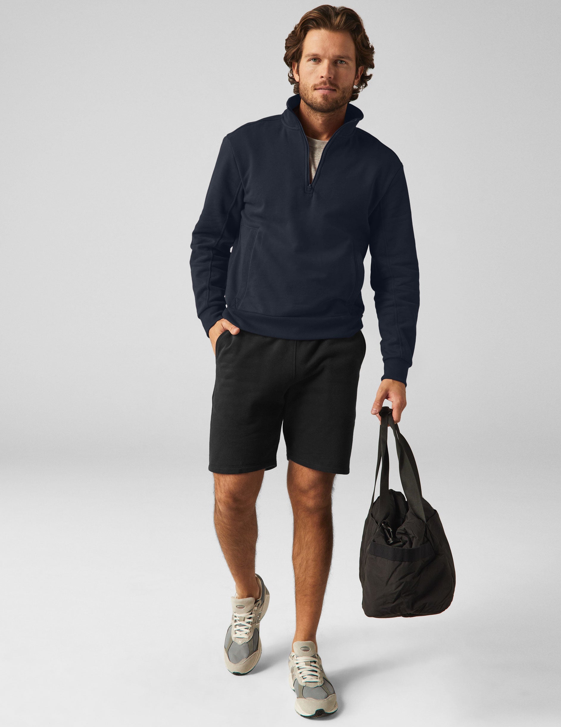 blue quarter zip men's pullover with a front pocket.
