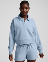 blue cropped long sleeve pullover with a v-neck collared neckline.