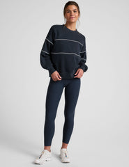 blue fleece crewneck sweater with white contrast piping trim at chest and sleeves.