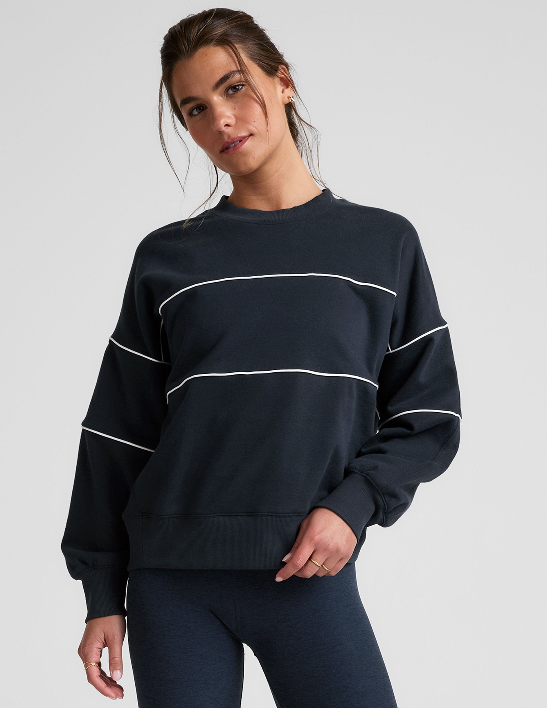 blue fleece crewneck sweater with white contrast piping trim at chest and sleeves.