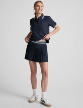 blue mini length pleated skirt with an exposed stripped elastic waistband and
internal performance shorts with pockets.