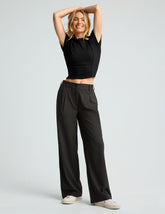 black mid rise jetstretch woven pants with cargo style pockets.