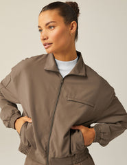 brown zip-up jetstretch woven jacket with a collar and pockets.
