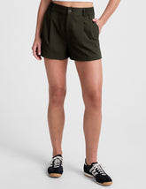 green shorts with side pockets and an elasticated waistband.