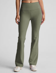 green high-waisted bootcut pants.