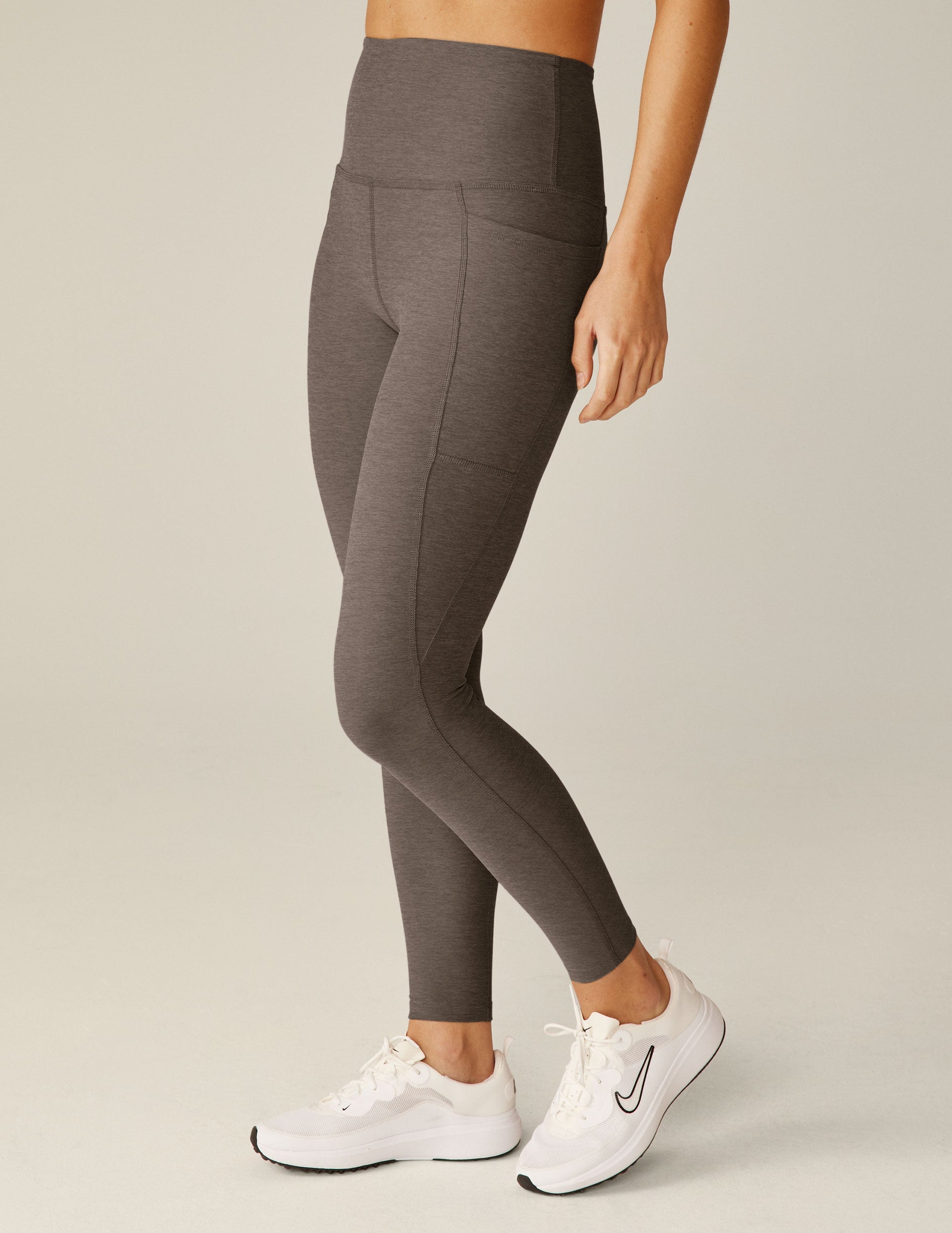 brown high-waisted midi leggings with pockets.