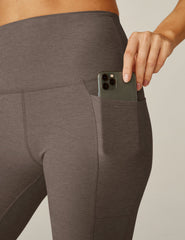 brown high-waisted midi leggings with pockets.