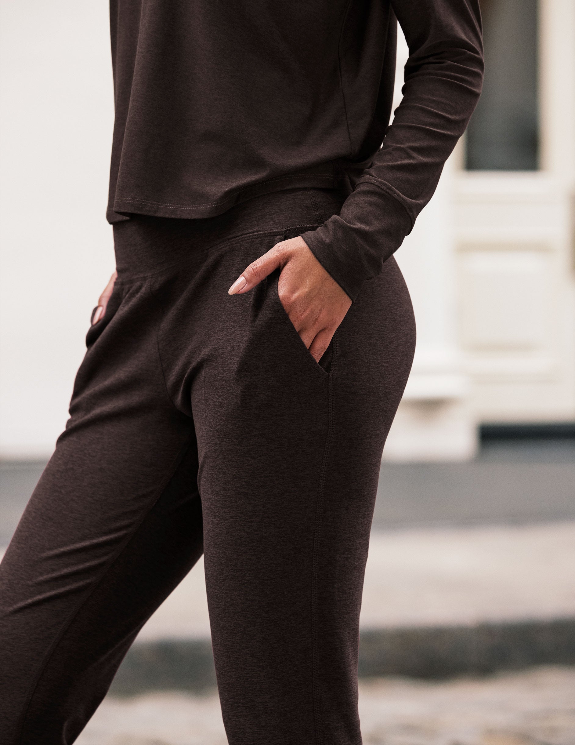 brown high-waisted midi length joggers with pockets.