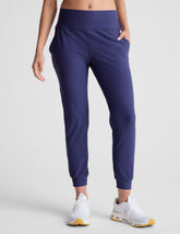 blue high-waisted midi length joggers with pockets.