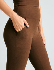 brown high-waisted flare pants with side pockets.