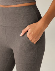 brown high-waisted flare pants with pockets.