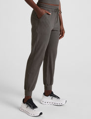 grey joggers with side pockets and a drawstring at waistband.