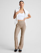 brown high-waisted bootcut pants with side pockets.