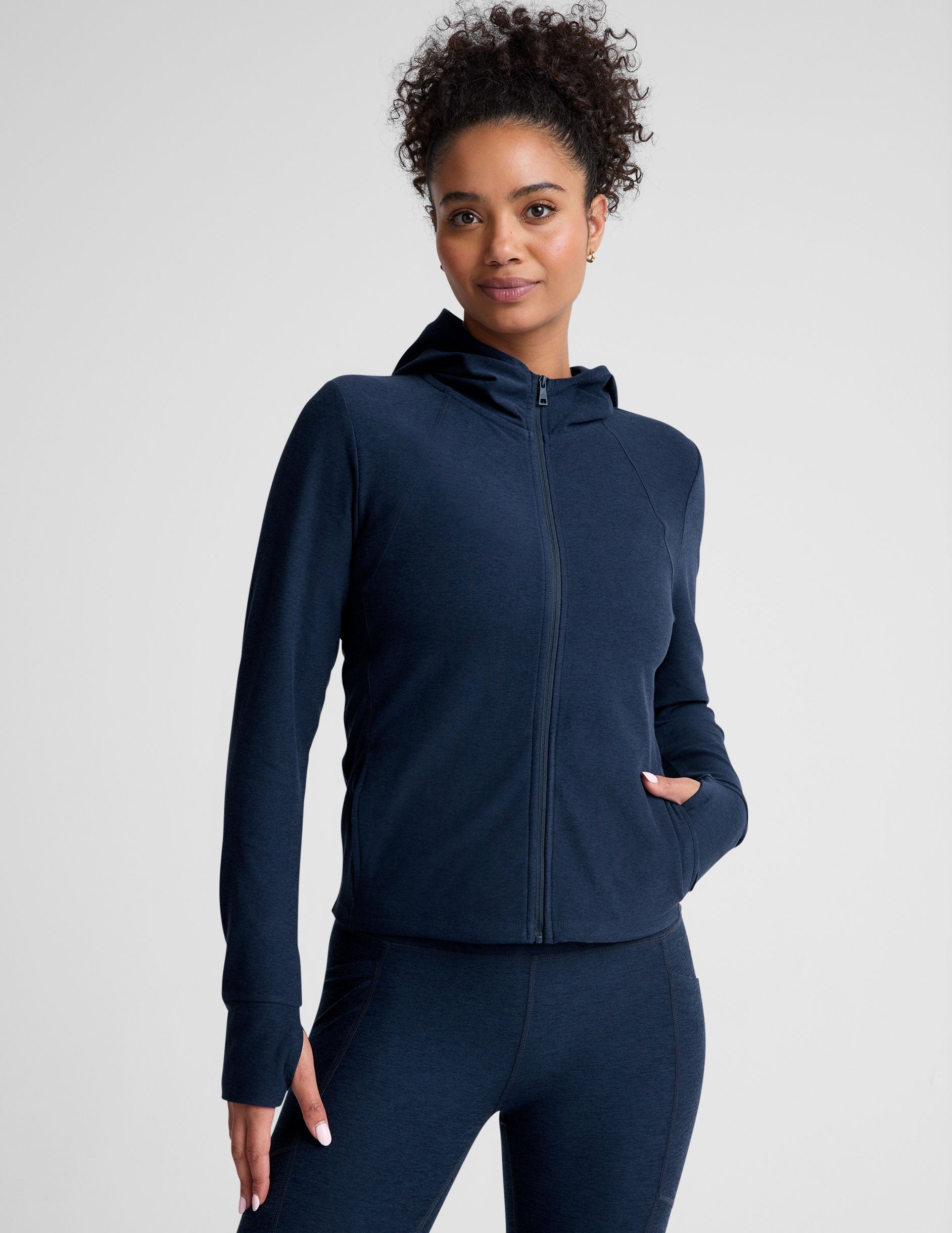 blue zip-up hooded jacket with thumbholes.