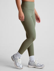 green high-waisted midi length leggings.