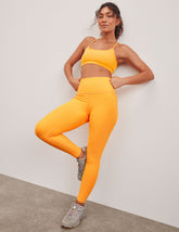 orange high-waisted midi length leggings.