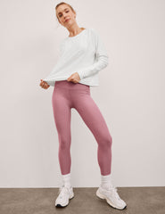 pink high-waisted midi length leggings.
